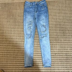 Kids size one, skinny ripped blue jeans. With a washed color.